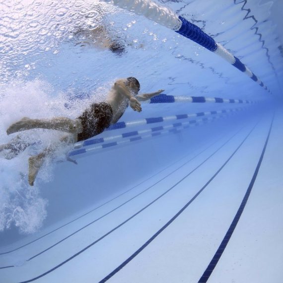 man swimming laps in lane