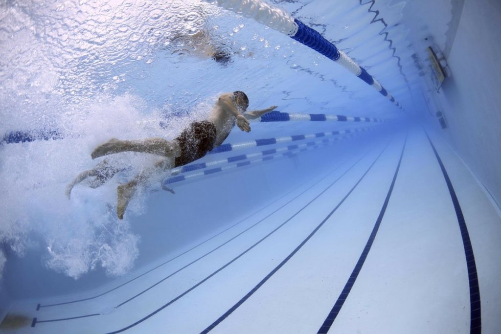 man swimming laps in lane