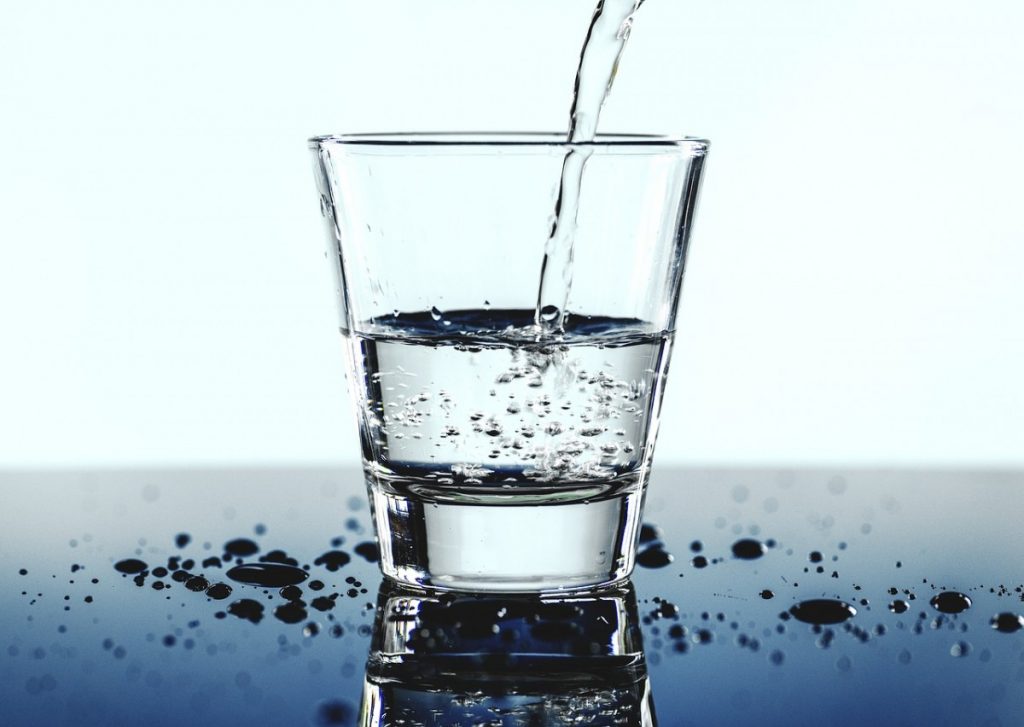 water being poured into a clear glass