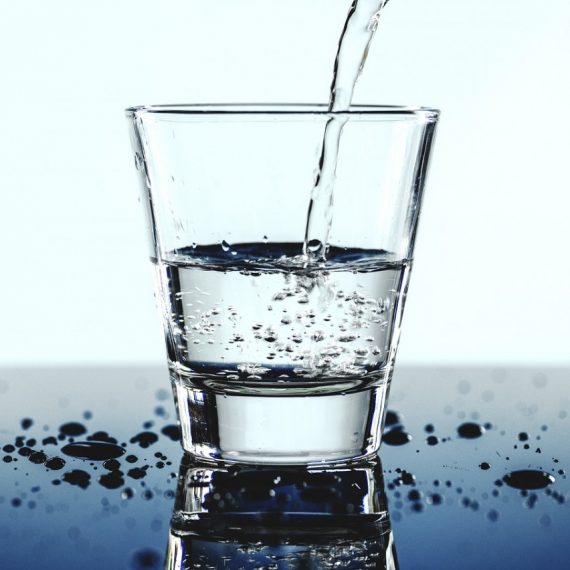 water being poured into a clear glass