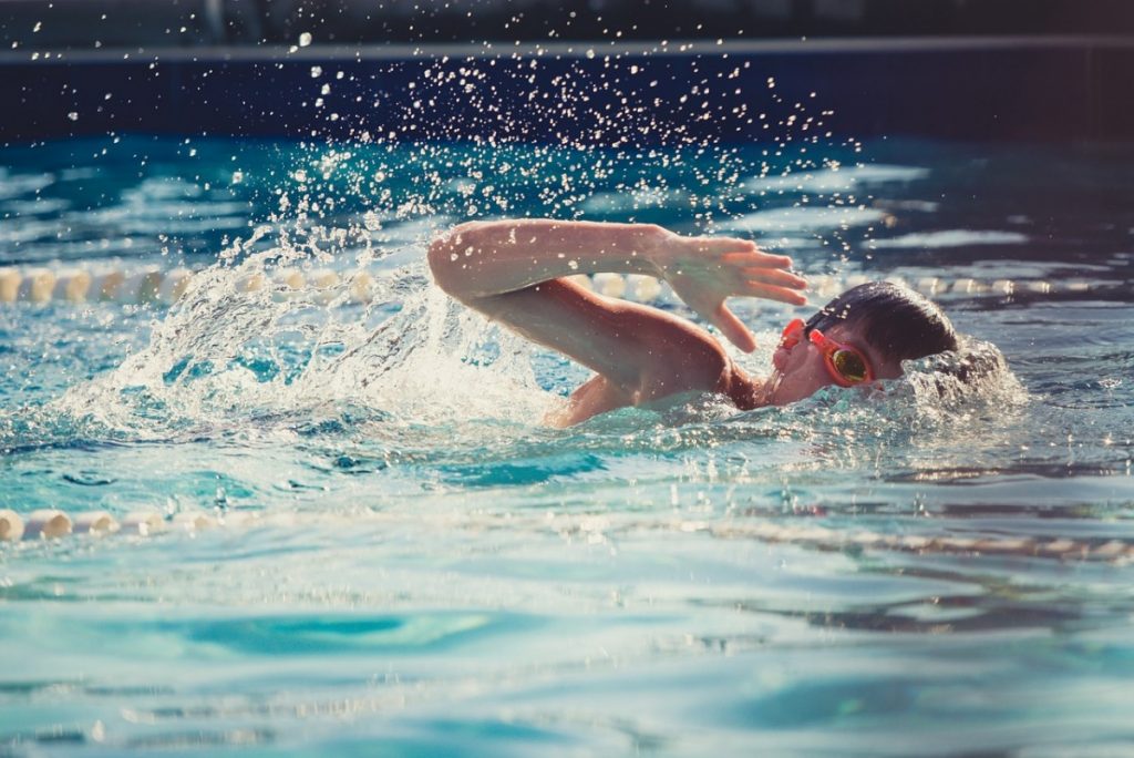 child swimming in pool