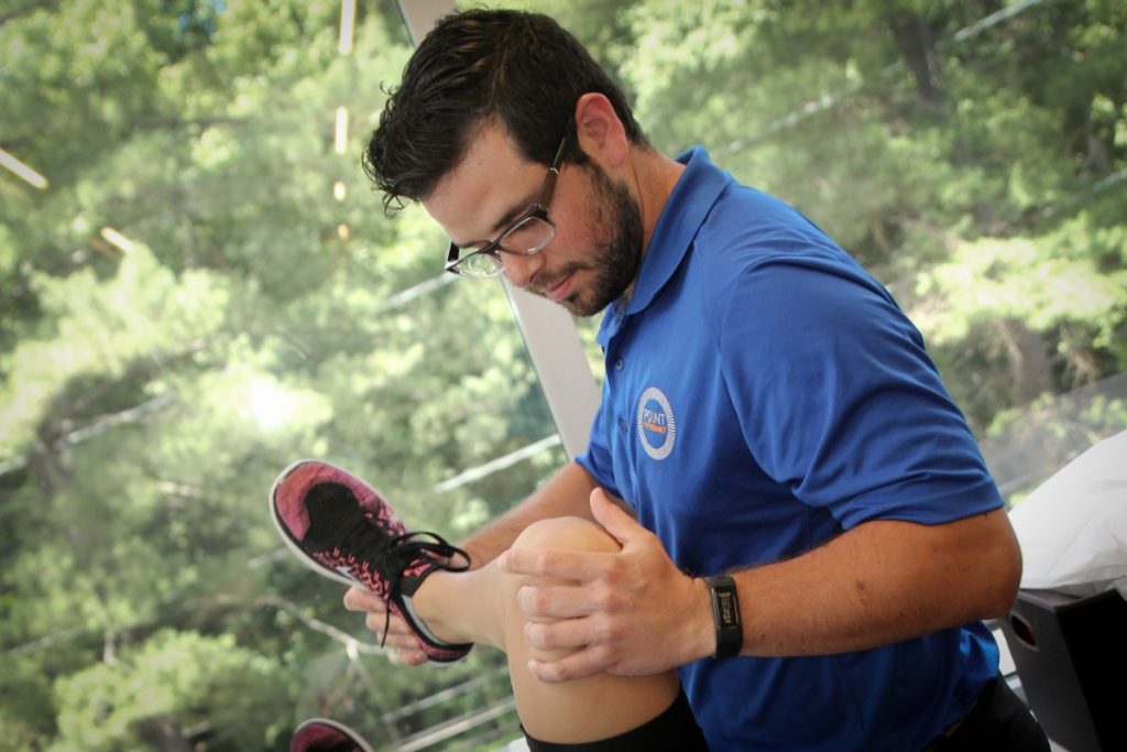 Point Performance physical therapist Adam Gershowitz works on a patient's knee osteoarthritis